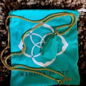 Kendra Scott Turquoise pendant on gold chain.